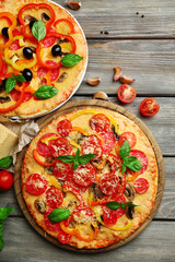 Delicious pizza served on wooden table