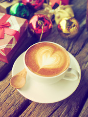 Coffee latte art and the X-mas present box on the wood backgroun