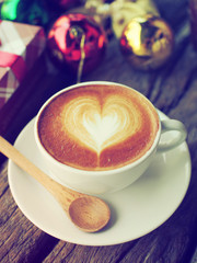 Coffee latte art and the X-mas present box on the wood backgroun