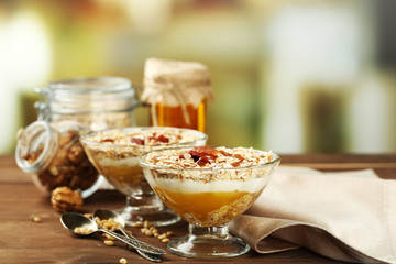 Tasty dessert with oat flakes and honey, on table