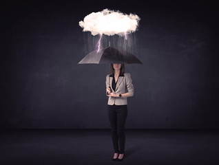 Businesswoman standing with umbrella and little storm cloud