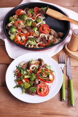 Braised wild mushrooms with vegetables and spices in pan and