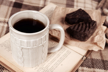 Cup of tea with book on table close-up