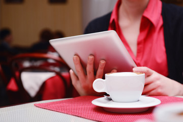 Woman with tablet computer in cafe shop
