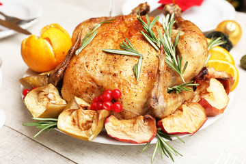 Baked chicken for festive dinner. Christmas table setting
