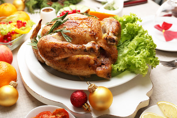 Baked chicken for festive dinner. Christmas table setting