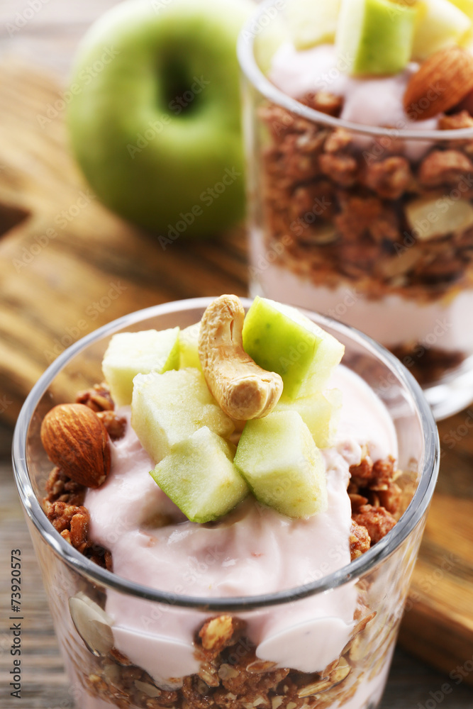 Wall mural healthy layered dessert with muesli and berries on table