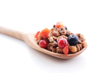 Granola in spoon isolated on white