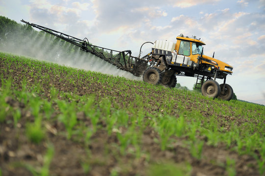 farm tractor spraying substances against pests in the field