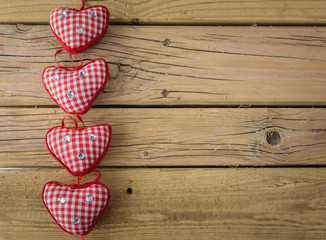 red check hearts on rustic wooden background