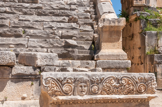 Stone mask and ancient amphitheater, Myra (Turkey)