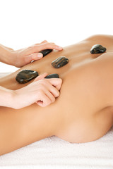 Young attractive woman getting hot stone massage