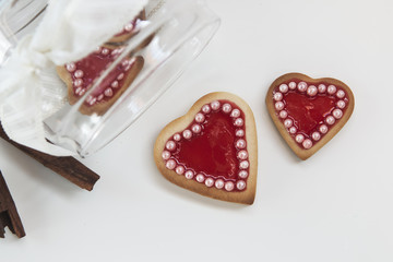 Romantic heart shaped homemade Valentine cookies over a white ba