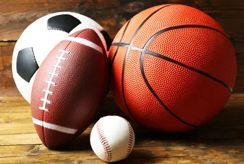 Fotobehang Sports balls on wooden background © Africa Studio
