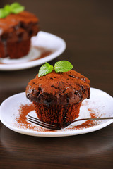 Yummy chocolate cupcake on table