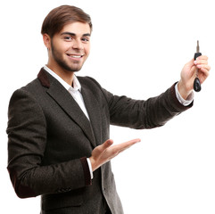 Businessman holding car key isolated on white