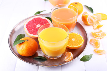 Grapefruit and tangerine juices on wooden table