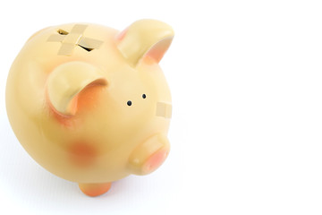 Piggy bank with medical patches, isolated on white background