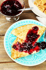 Plate of delicious pancakes with berry jam