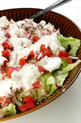 Green salad with red vegetables and yogurt