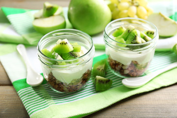 Healthy dessert with muesli and fruits on table