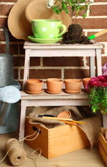Flowers in wooden box, pots and garden tools