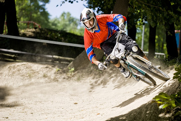Mountainbiker rides on track in forest