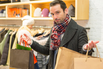 Young casual man waiting while his wife's shopping