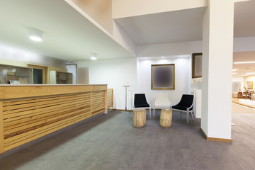 Spacious hotel lobby with reception desk 