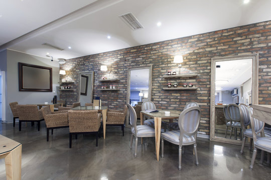 Interior of a modern hotel cafe with stone wall 