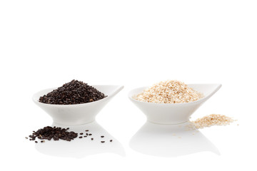Black and white sesame seeds isolated on white.