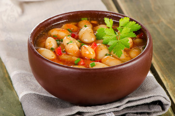 Baked beans in  bowl on  wooden background .