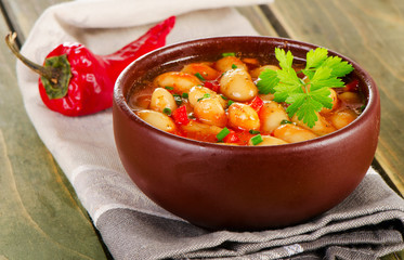 Baked beans in  bowl on  a wooden background .