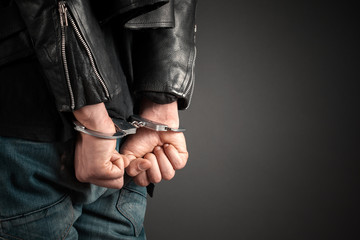 man hands in handcuffs