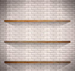 Empty wood shelves on white brick background.