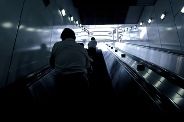 people rushing on the escalator
