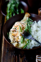 Baked sea bass with tomatoes, feta cheese, rosemary and garnishe