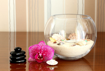 orchid and black stones close up...