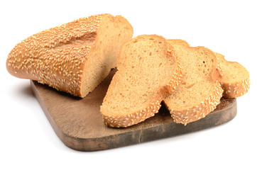 sliced loaf of bread on a cutting board isolated on white