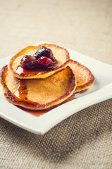 pancakes with jam and coffee on burlap background