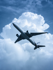 Fototapeta na wymiar Passenger airplane flying in the sky processed in blue
