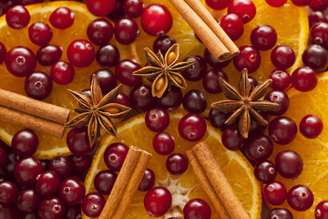 Cinnamon sticks, star anise, orange slices and cranberries