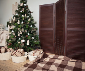 Fototapeta na wymiar Christmas tree with presents underneath in living room