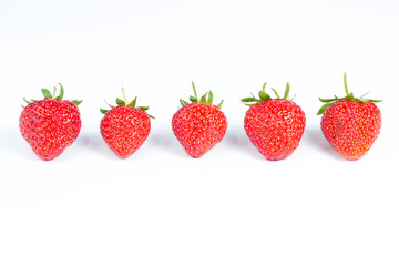 Group of five strawberries isolated on white