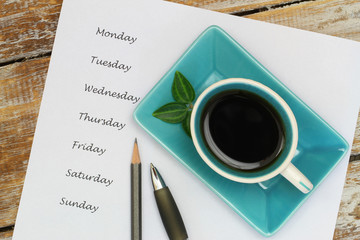 Coffee and weekdays listed on white piece of paper