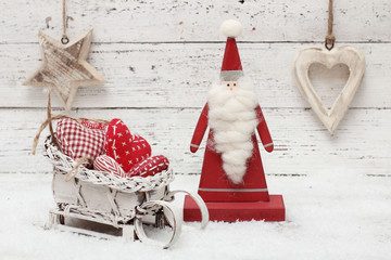 Santa Claus and christmas decoration on wooden background in sca