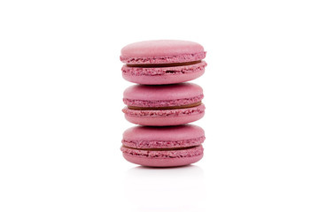 Three red colored macaroons isolated