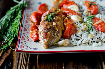 Red mullet baked with tomato, garlic and rosemary with a garnish