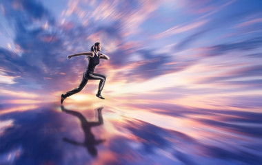 Fototapeta na wymiar Woman running against coloured sky