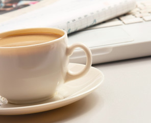 Cup of coffee near press.